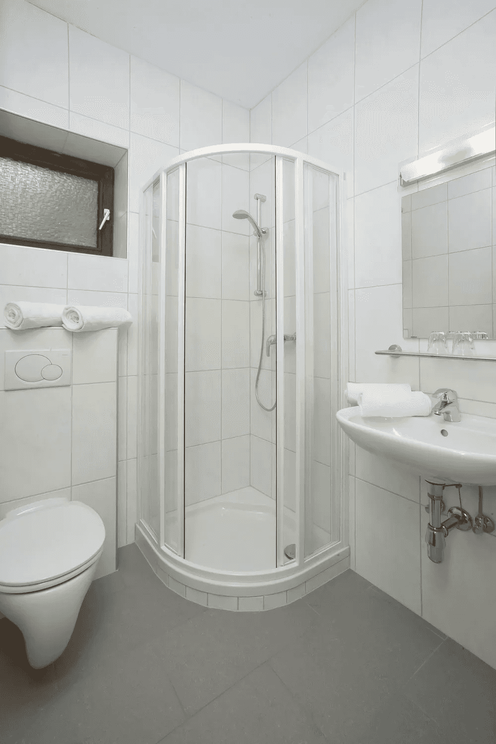 Badezimmer mit Duschkabine, Waschbecken und WC